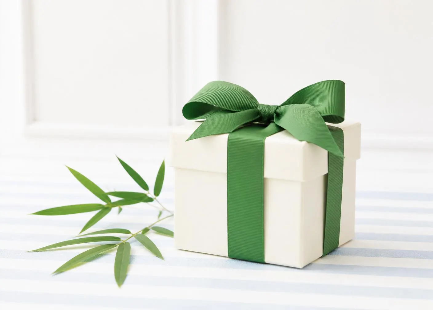 Boutique gift box with green ribbon